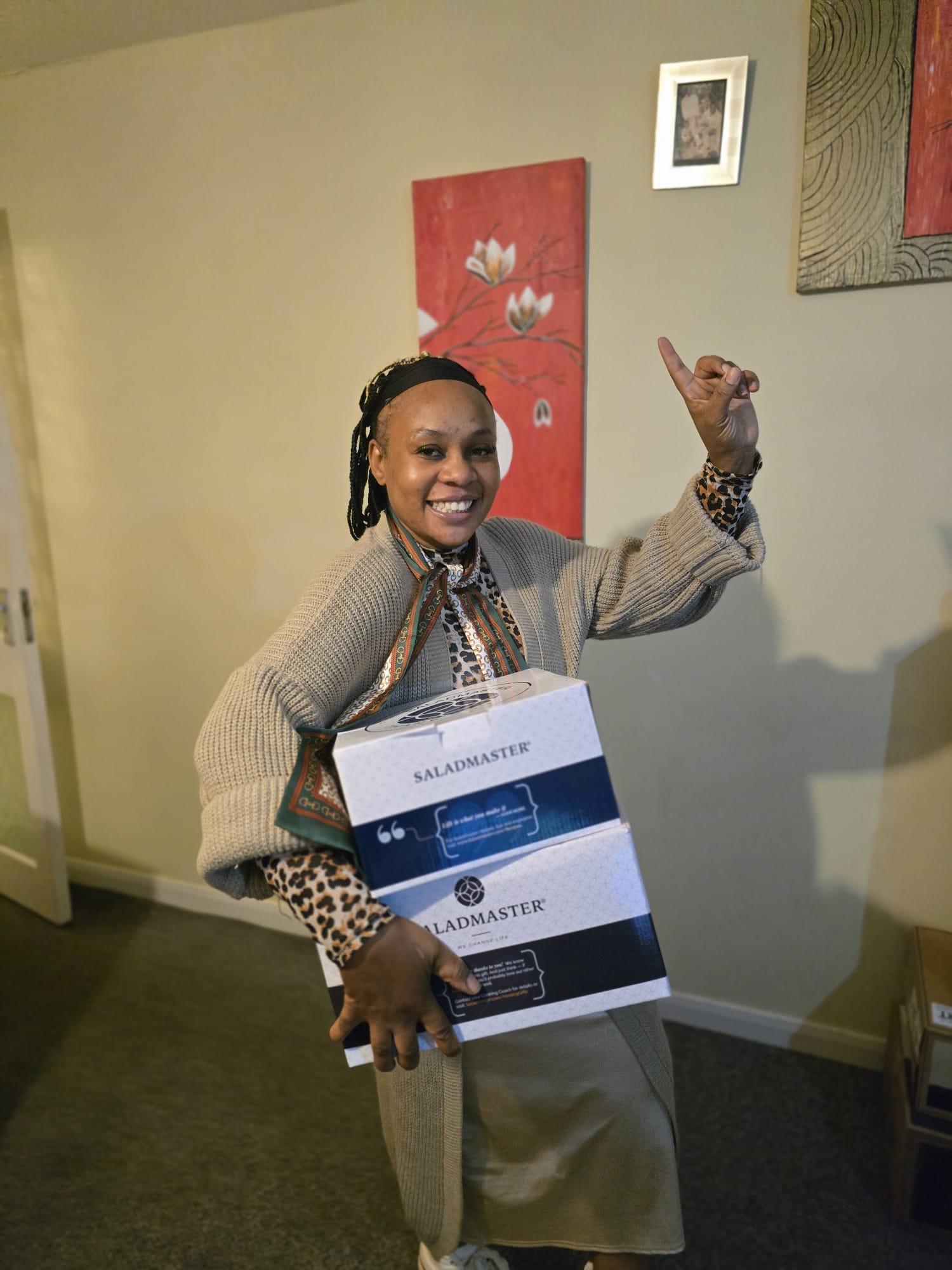 Delighted customer celebrating with her new Saladmaster cookware gift boxes