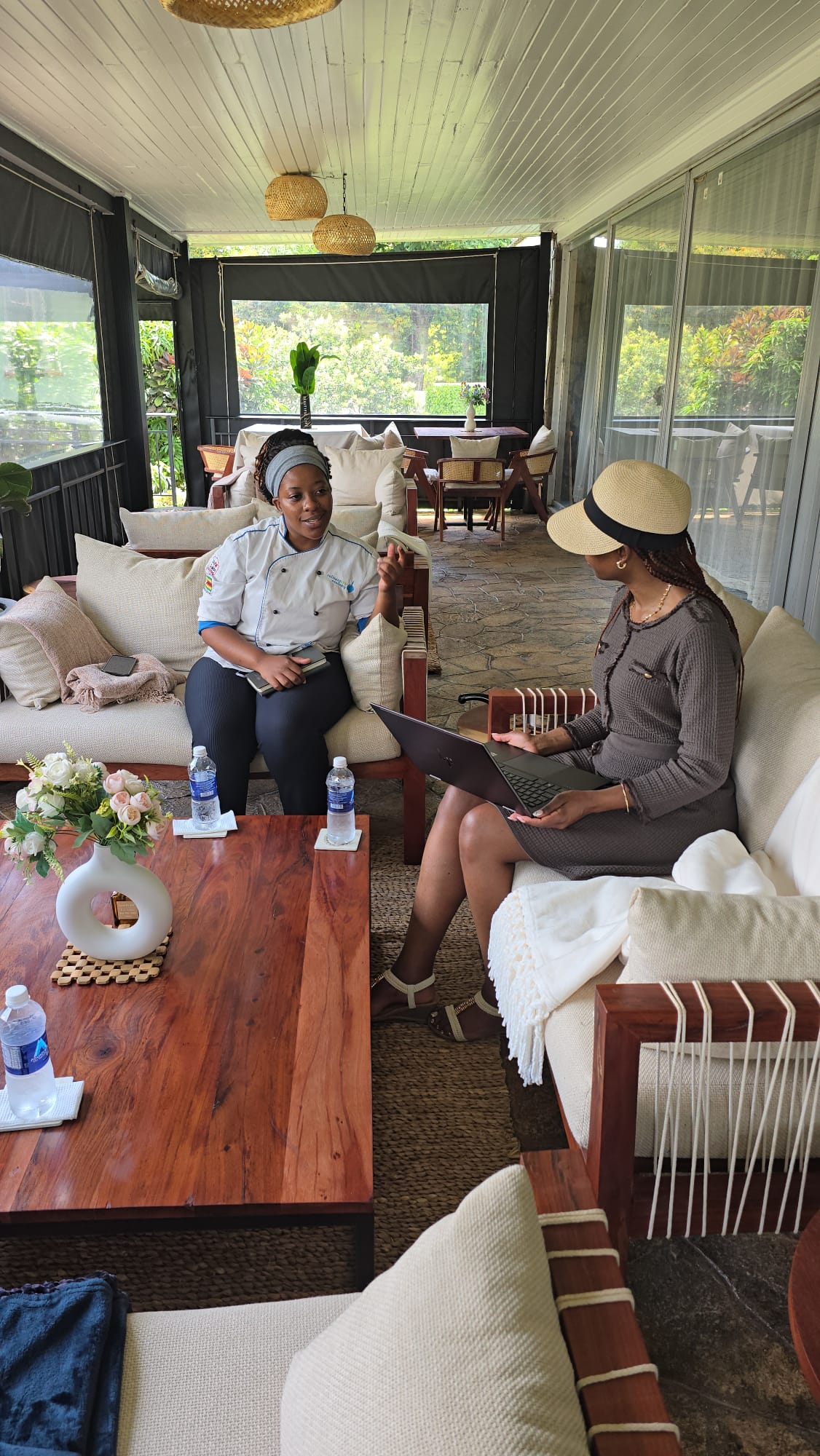 Consultant meeting a professional chef to discuss Saladmaster cookware in a bright veranda lounge