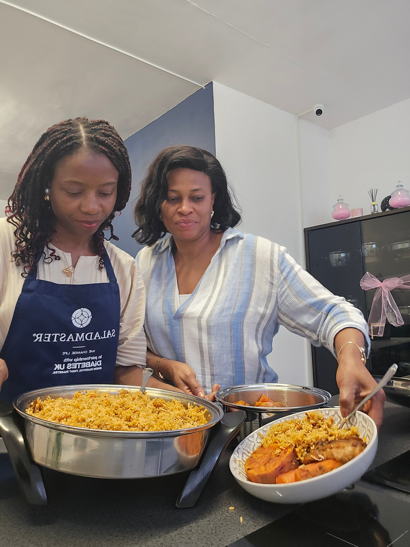Two women serving a freshly cooked Saladmaster meal together