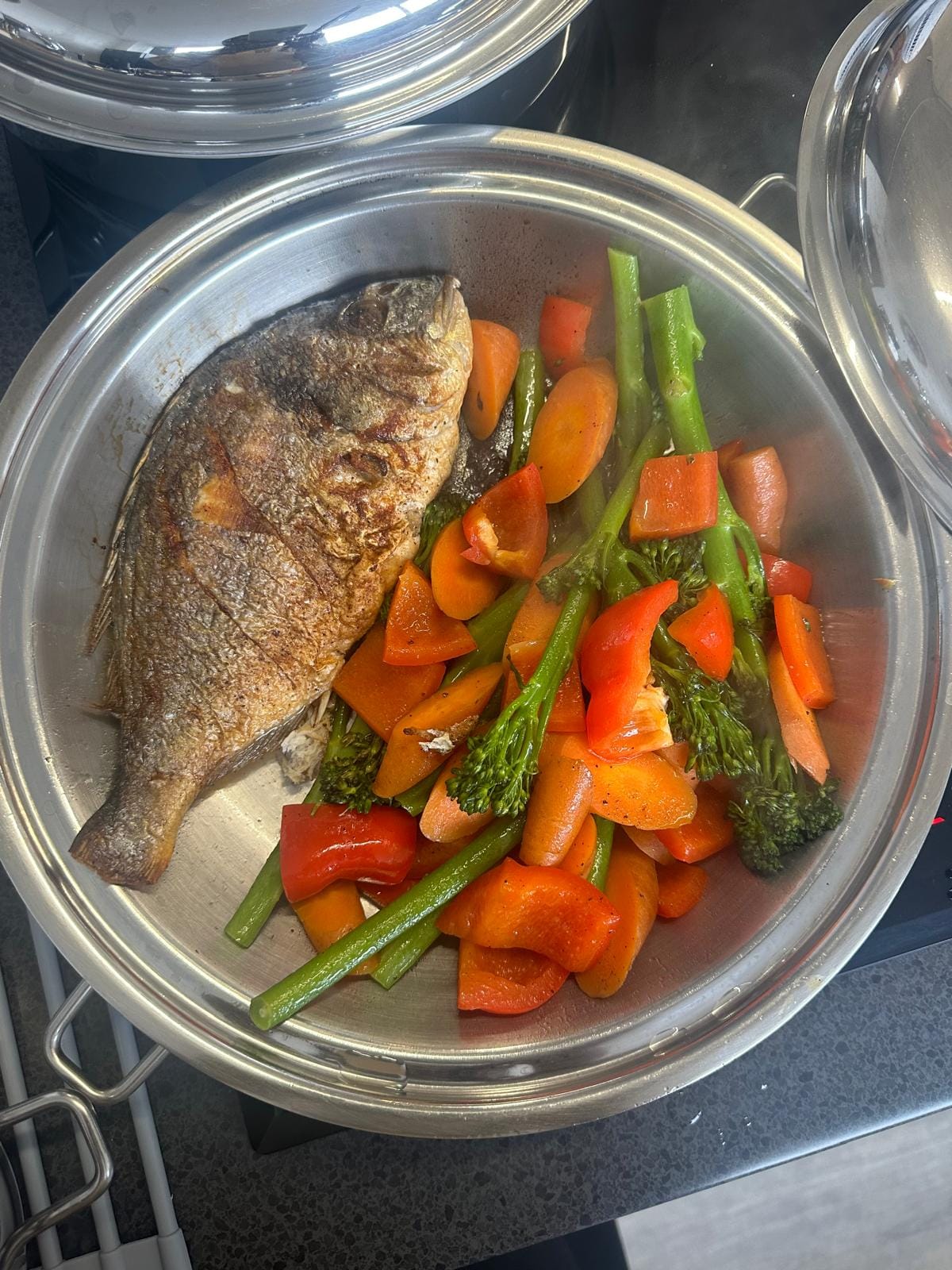 Whole seabass with broccoli, carrots and red peppers steamed together in a Saladmaster stainless steel pan