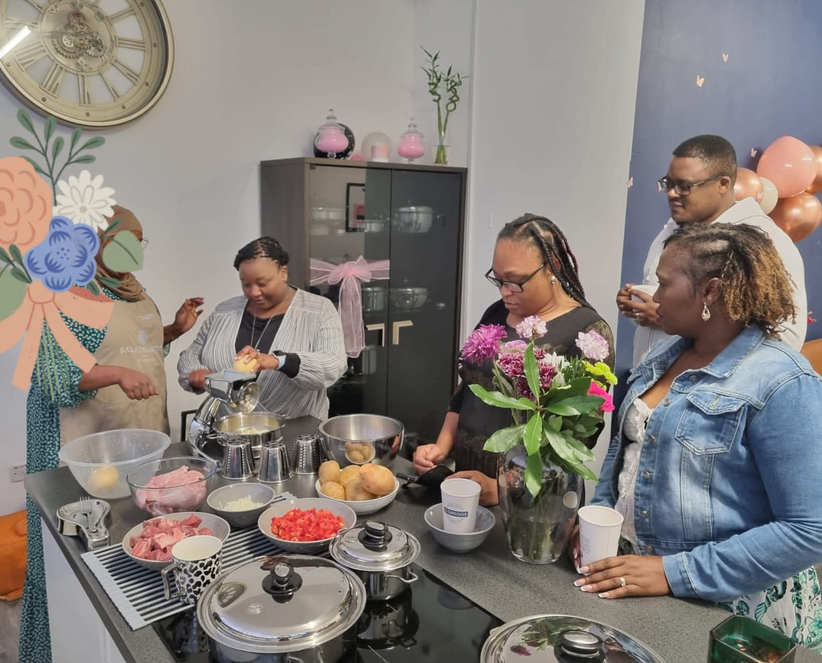 Live Saladmaster food prep demonstration with guests gathered around the kitchen island in Leeds