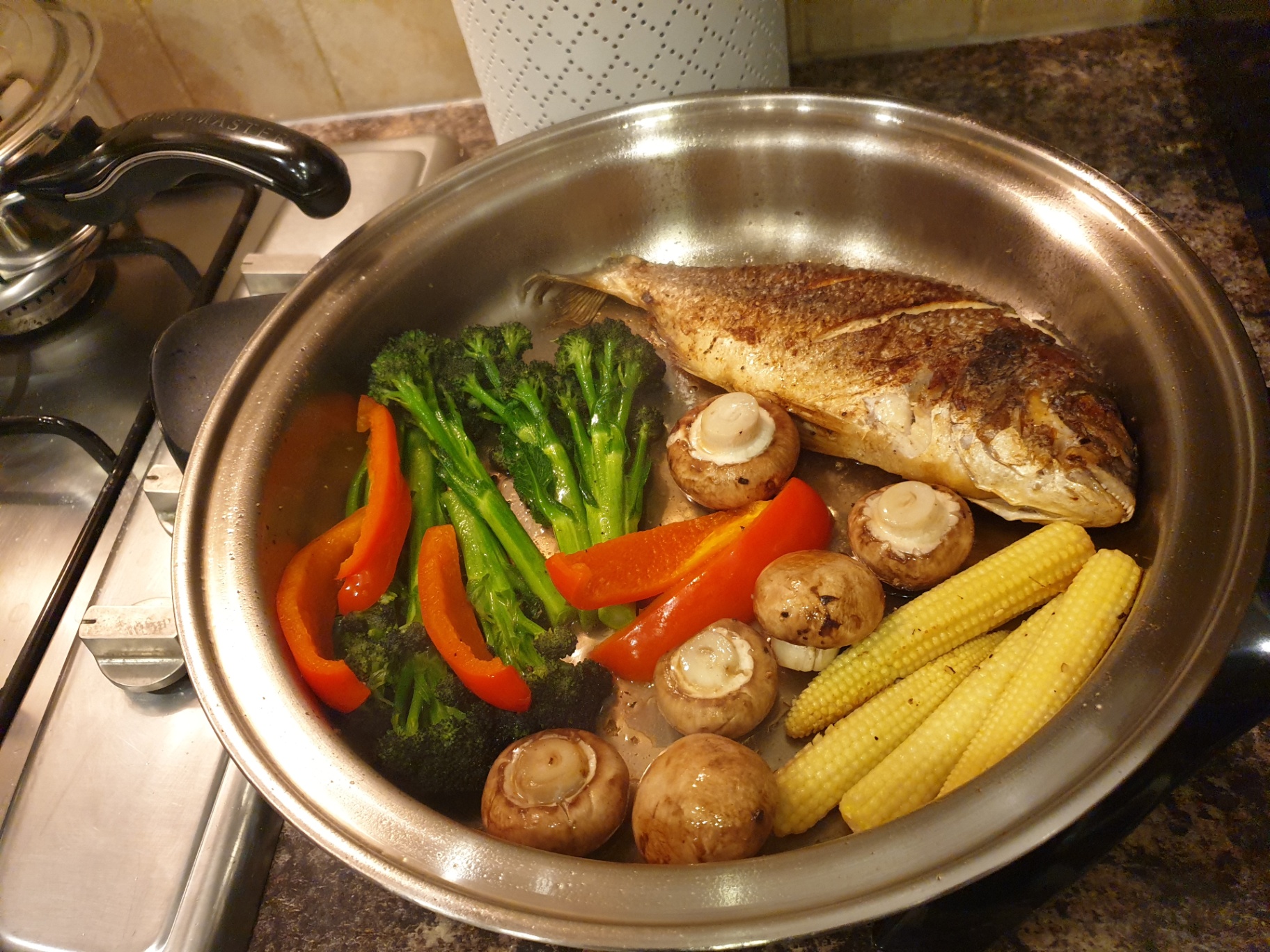 Whole fish with vegetables cooking in a Saladmaster pan
