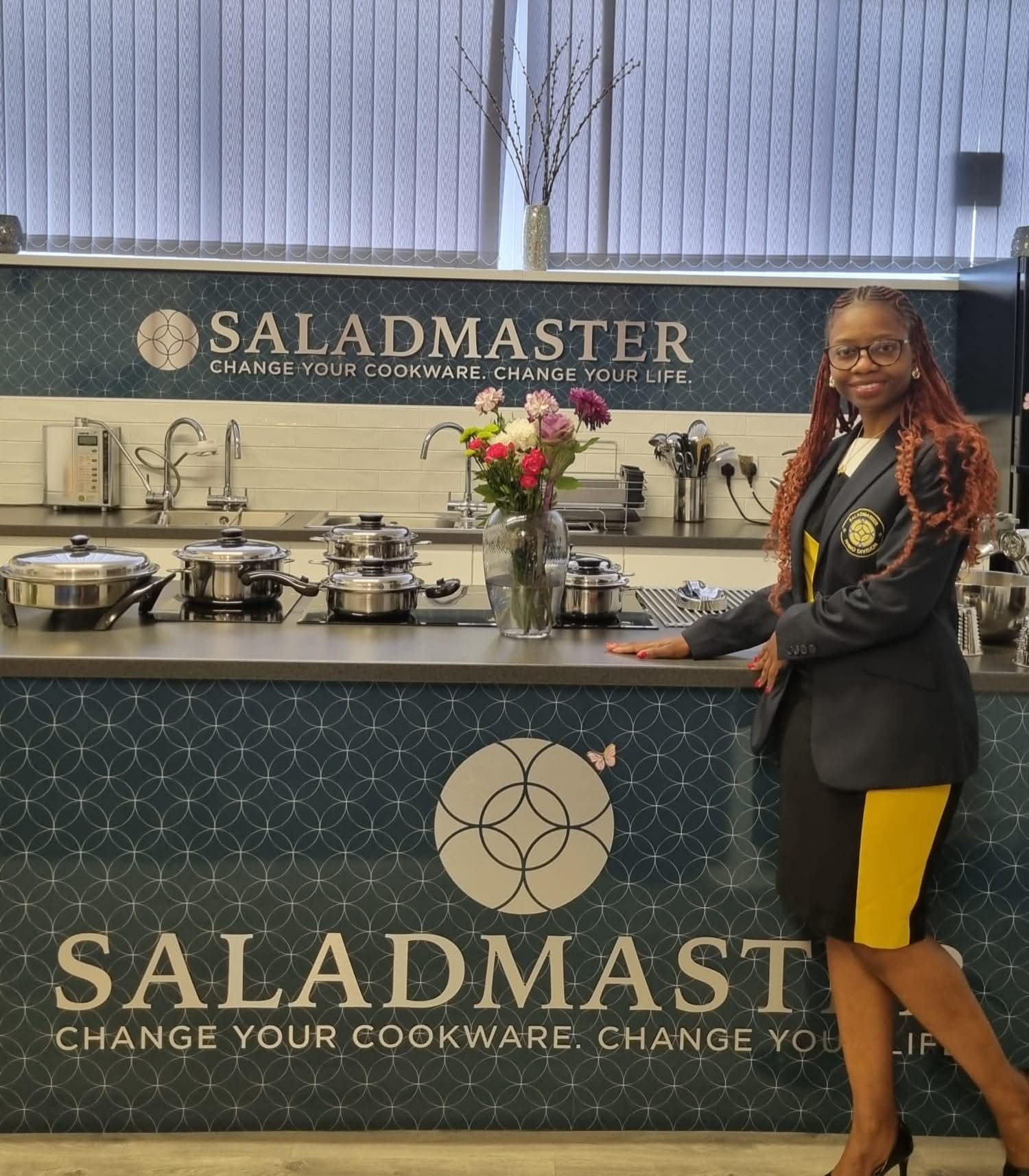 Authorised Saladmaster dealer in Rhino Division blazer at the Saladmaster Bramley Leeds studio cooktop